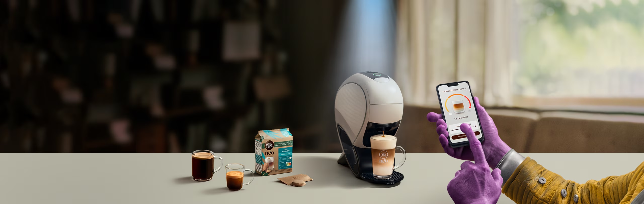 Uma mão alienígena a usar a aplicação NESCAFÉ® Dolce Gusto® para personalizar o seu café. NEO, máquina smart latte, pack de café e bebidas.
