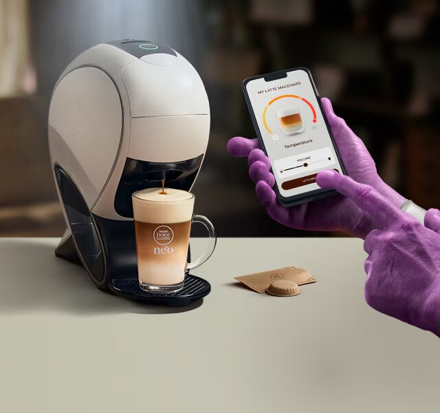 Uma mão alienígena a usar a aplicação NESCAFÉ® Dolce Gusto® para personalizar o seu café. NEO, máquina smart latte, pack de café e bebidas.